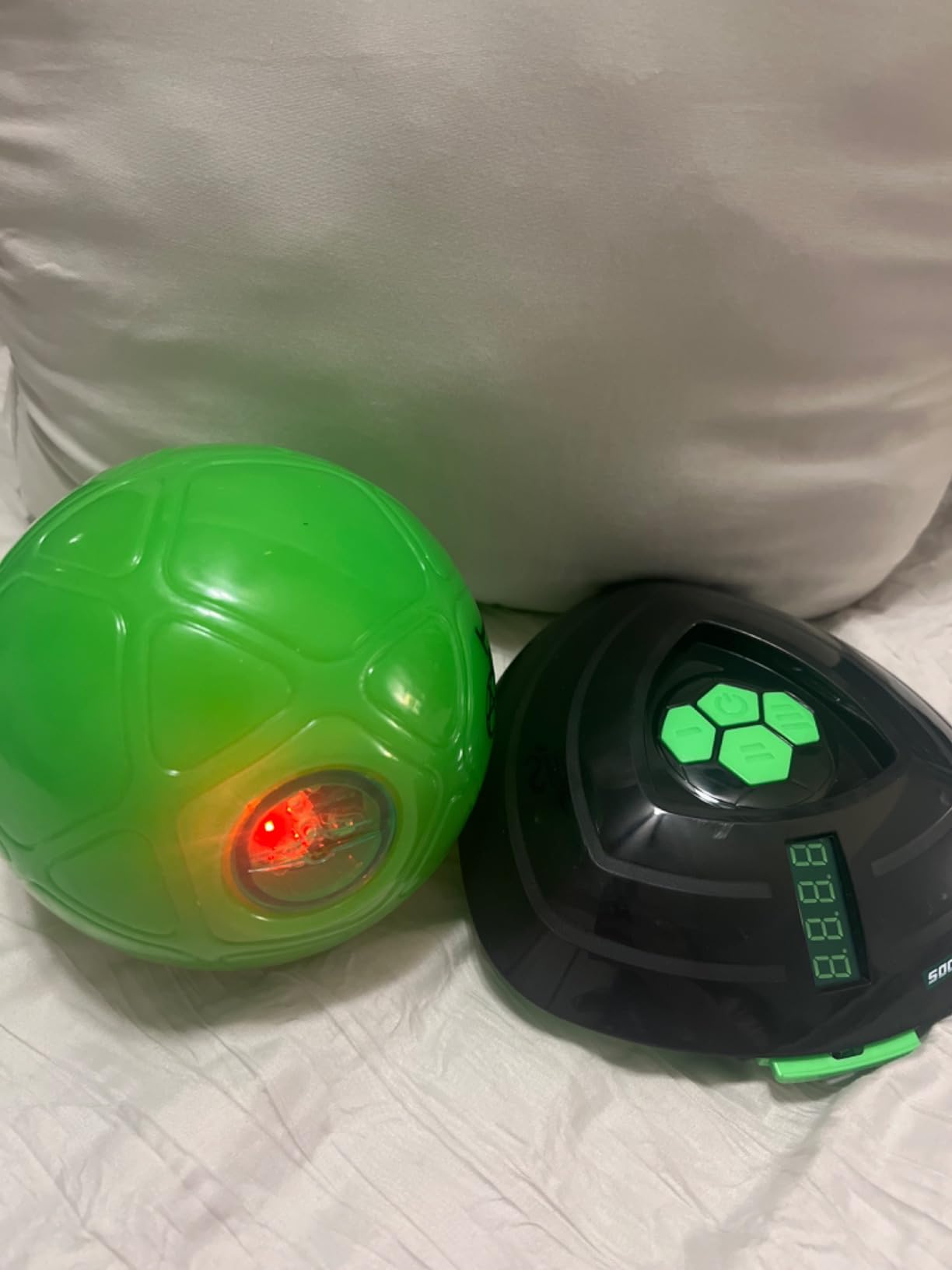 Customer photo of the Soccer Bot robot with its LCD display and the green smart ball with its red sensor light on